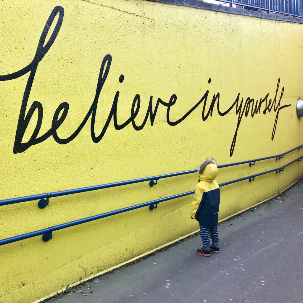 believe in yourself written on a wall