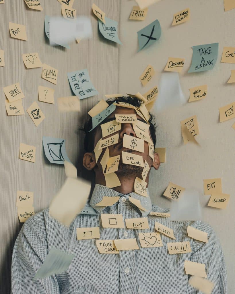 man surrounded and covered with stick notes