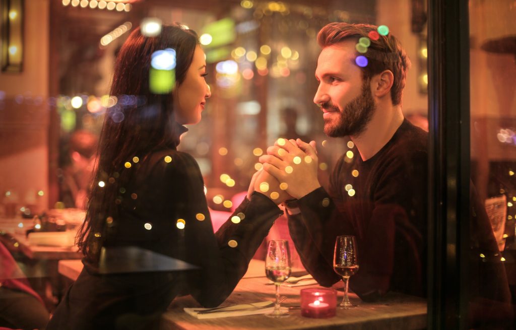 people relaxing on a romantic restaurant date