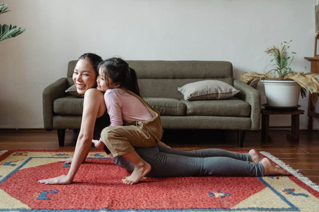 child and mother doing yoga