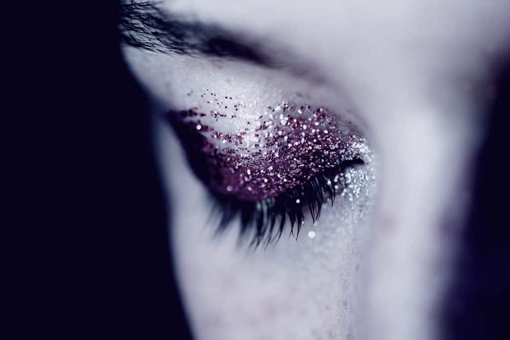 eye with glitter eyeshadow crying